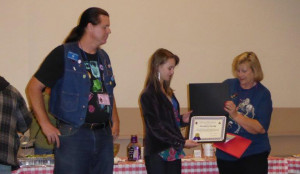 Rob Sankovich, Scholarship Chair, looks on as VGMS President Diane Cook awards Alexandra Nicklin the 2015 VGMS Scholarship.